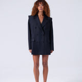 Woman wearing a black blazer set on a white background