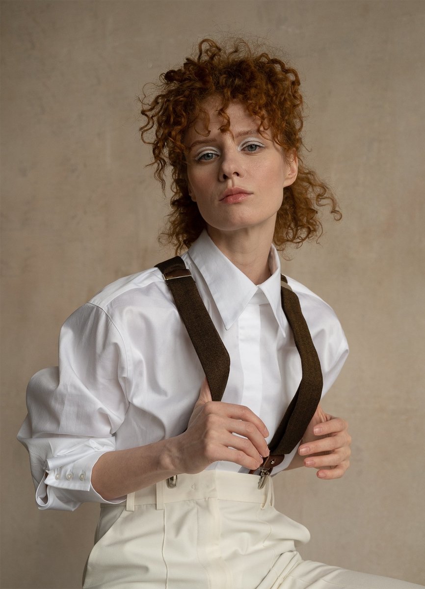 Confident woman wearing premium white cotton business shirt with wool suspenders