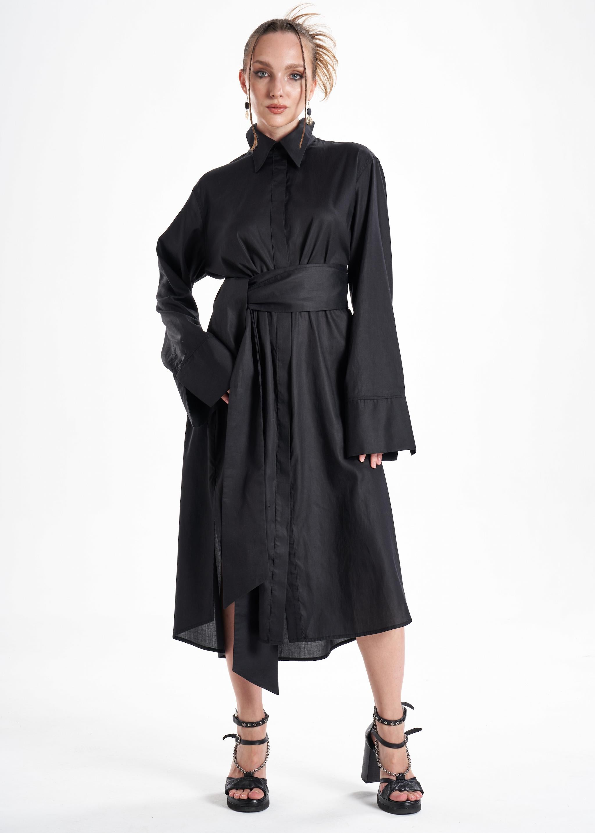 Black maxi shirt dress worn by a model from the front, showcasing the belted waist and relaxed fit