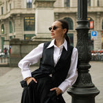 Model in Milan wearing a premium white cotton shirt under a tailored black waistcoat with wide-leg suit pants for an office look