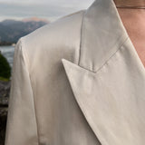 Peaked-lapel linen-blend Italian jacket highlighting structured shoulder construction and refined twill texture