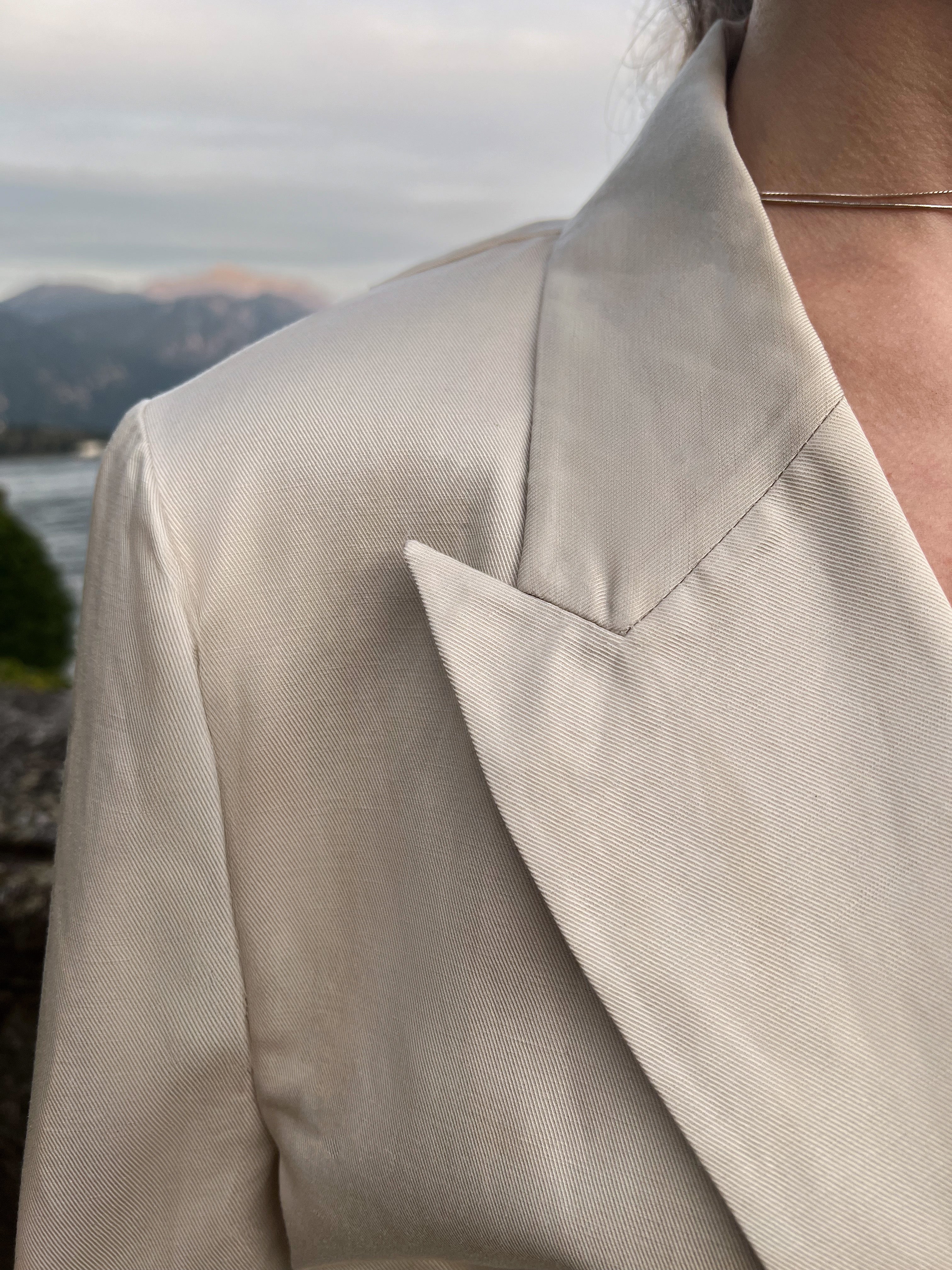 Peaked-lapel linen-blend Italian jacket highlighting structured shoulder construction and refined twill texture