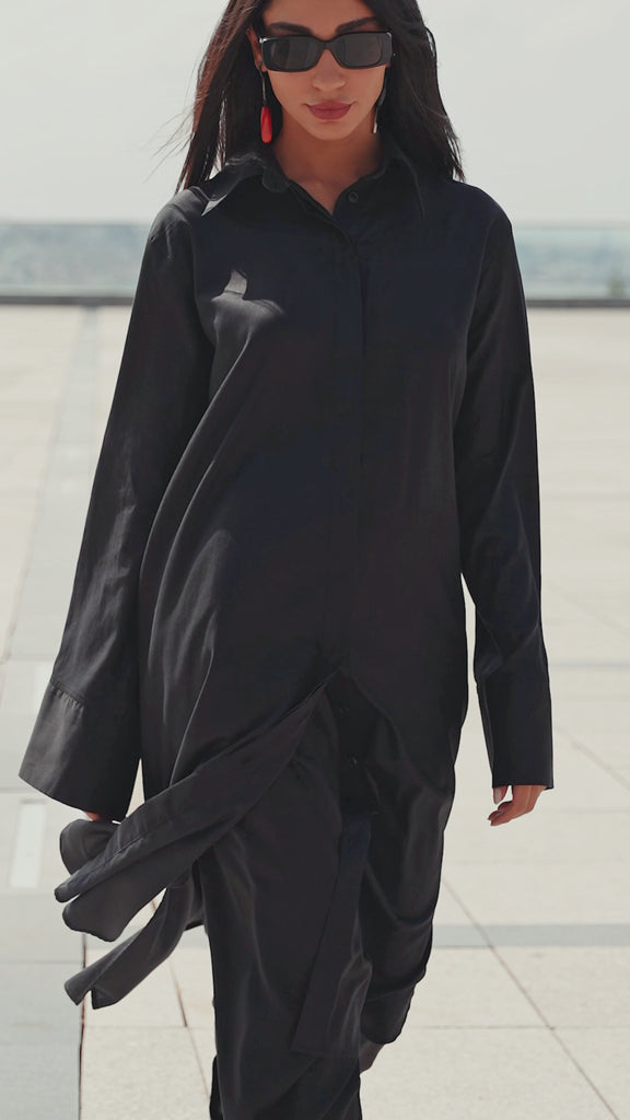Black maxi shirt dress worn by a model walking outdoors, highlighting graceful movement and fluid drape