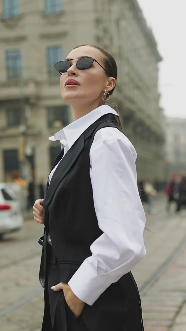 Video of a model wearing a relaxed-fit white business shirt, showing the drape and movement while walking