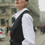 Video of a model wearing a relaxed-fit white business shirt, showing the drape and movement while walking