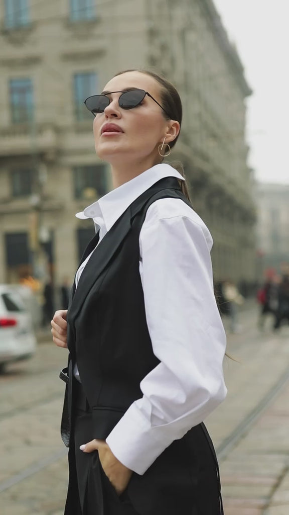 Video of a model wearing a relaxed-fit white business shirt, showing the drape and movement while walking