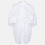 Prima white open-back shirt shown without a model from the back, revealing the drawstring construction