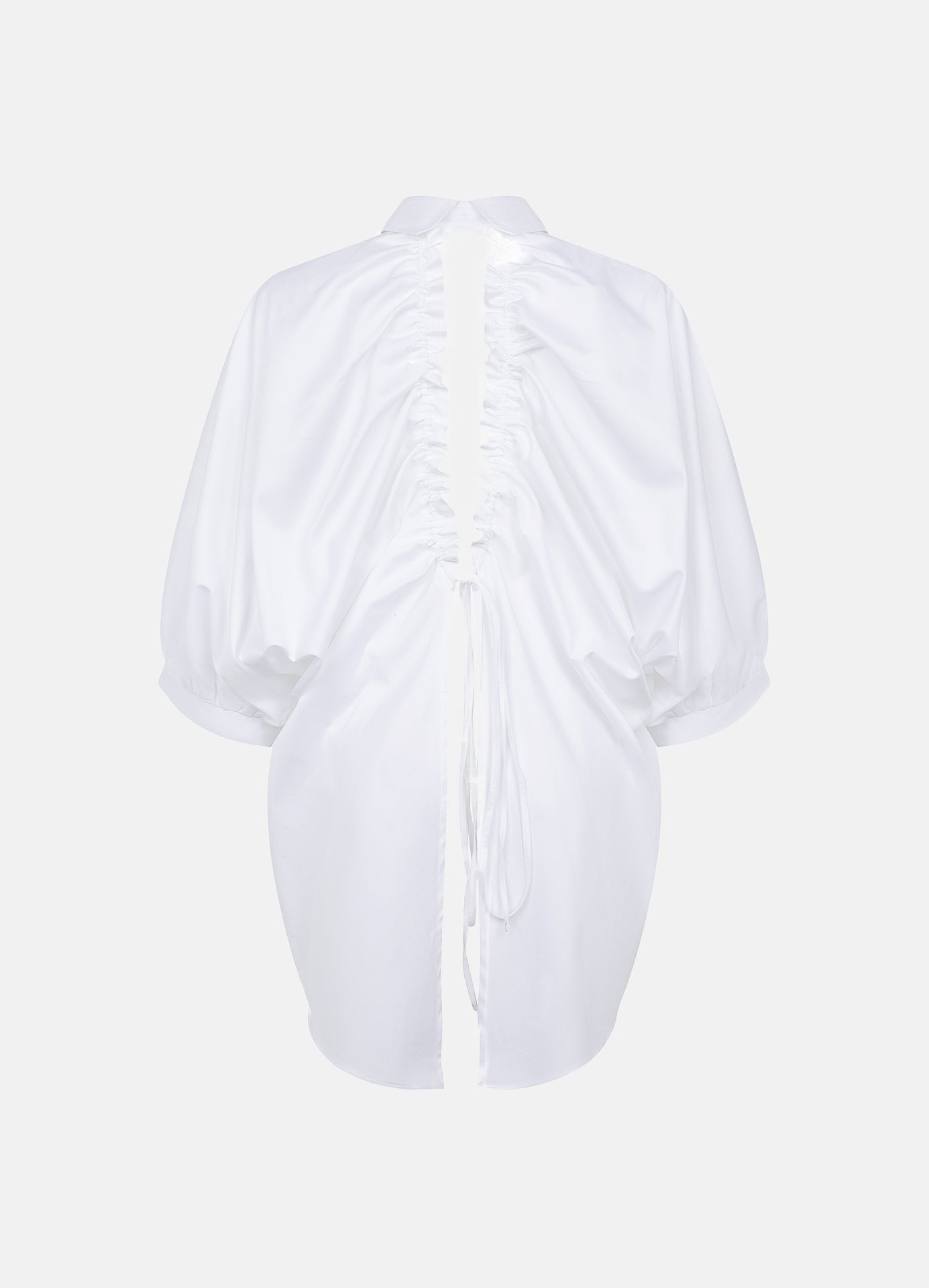 Prima white open-back shirt shown without a model from the back, revealing the drawstring construction