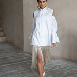Relaxed-fit white cotton shirt with voluminous puff sleeves and cold-shoulder detailing, styled on a model