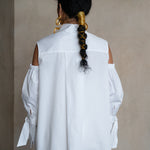 Split-back collar white cotton gabardine shirt with relaxed silhouette and cold-shoulder detailing, rear view on a model