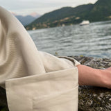 Turn-back cuff linen jacket with refined twill texture, close-up on a model overlooking Lake Como