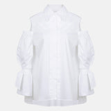 White cotton gabardine shirt with cold-shoulder design, puff sleeves and elongated relaxed fit, front product view