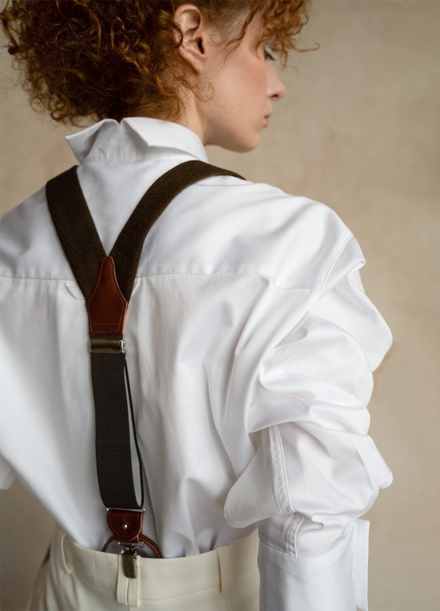 Woman in white business shirts with wool suspenders, back view