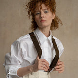 Confident woman wearing premium white cotton business shirt with wool suspenders