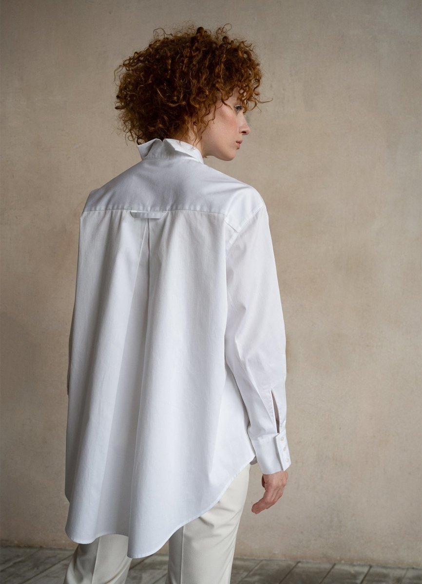 Woman standing in premium white oversized business shirt, structured fit, back view
